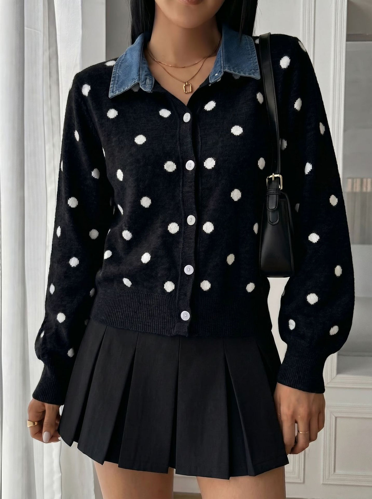 Polka-Dot Cardigan with Denim Collar in Black — front view on model with a mini skirt