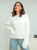 Relaxed Crew-Neck Knit Sweater in Ivory — front view on model