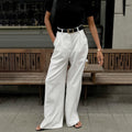 High-Waist Pleated Wide-Leg Trousers in White — front view on model, full length