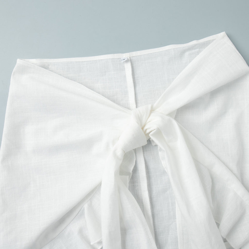 Tie-Front Cotton Mini Shirt Dress in White — close-up of the waist tie
