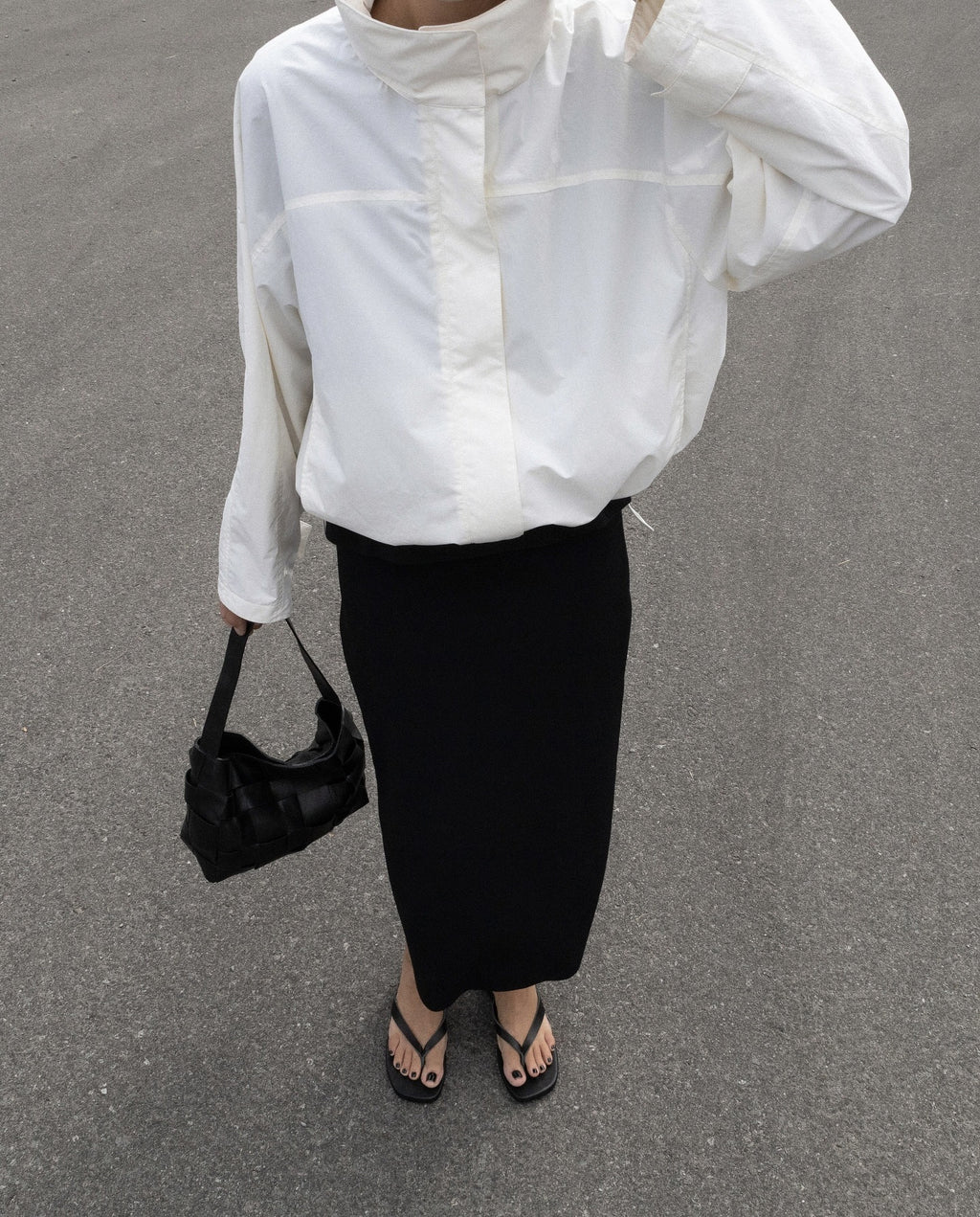 Oversized Stand-Collar Nylon Jacket with Drawcord Hem in White — on model with a midi skirt