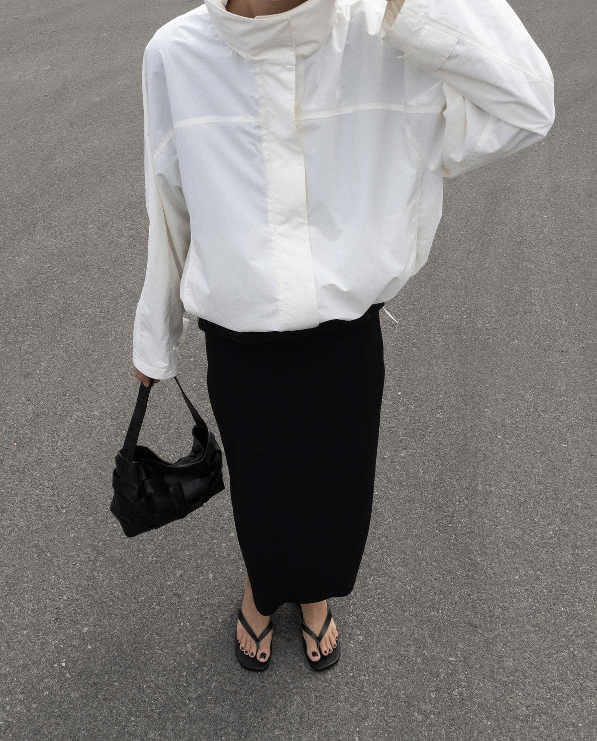Oversized Stand-Collar Nylon Jacket with Drawcord Hem in White — on model with a midi skirt