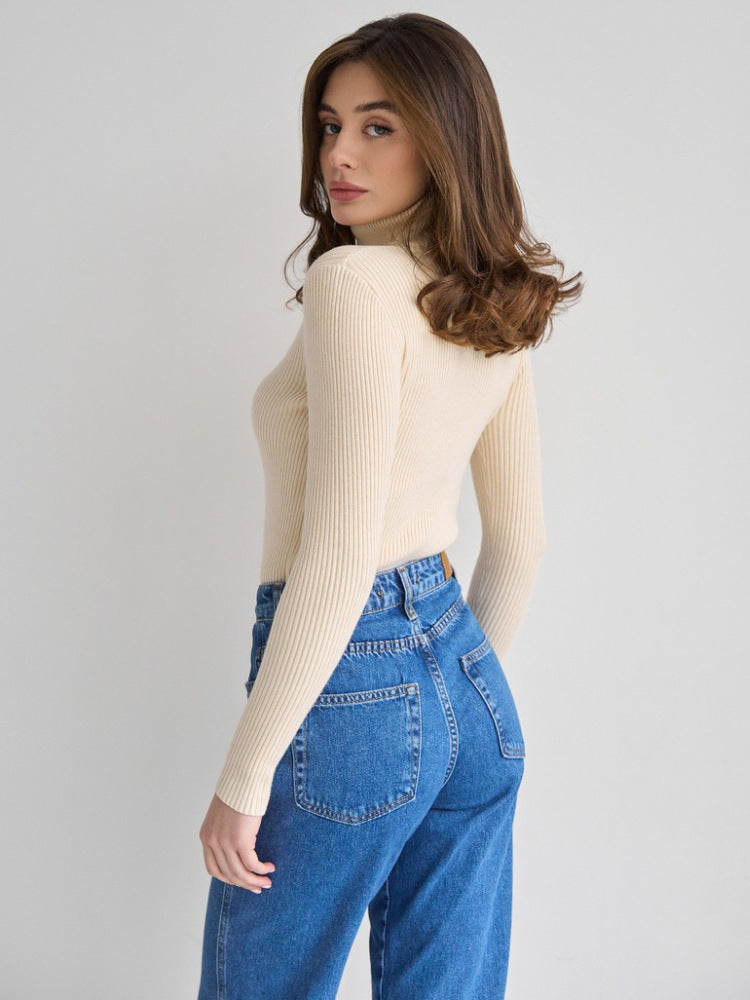 Fitted Ribbed Turtleneck Sweater in Cream — back view on model