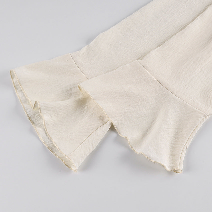 Ruffle Tie-Front Blouse and Wide-Leg Pants Set in Cream — close-up of the ruffle cuff