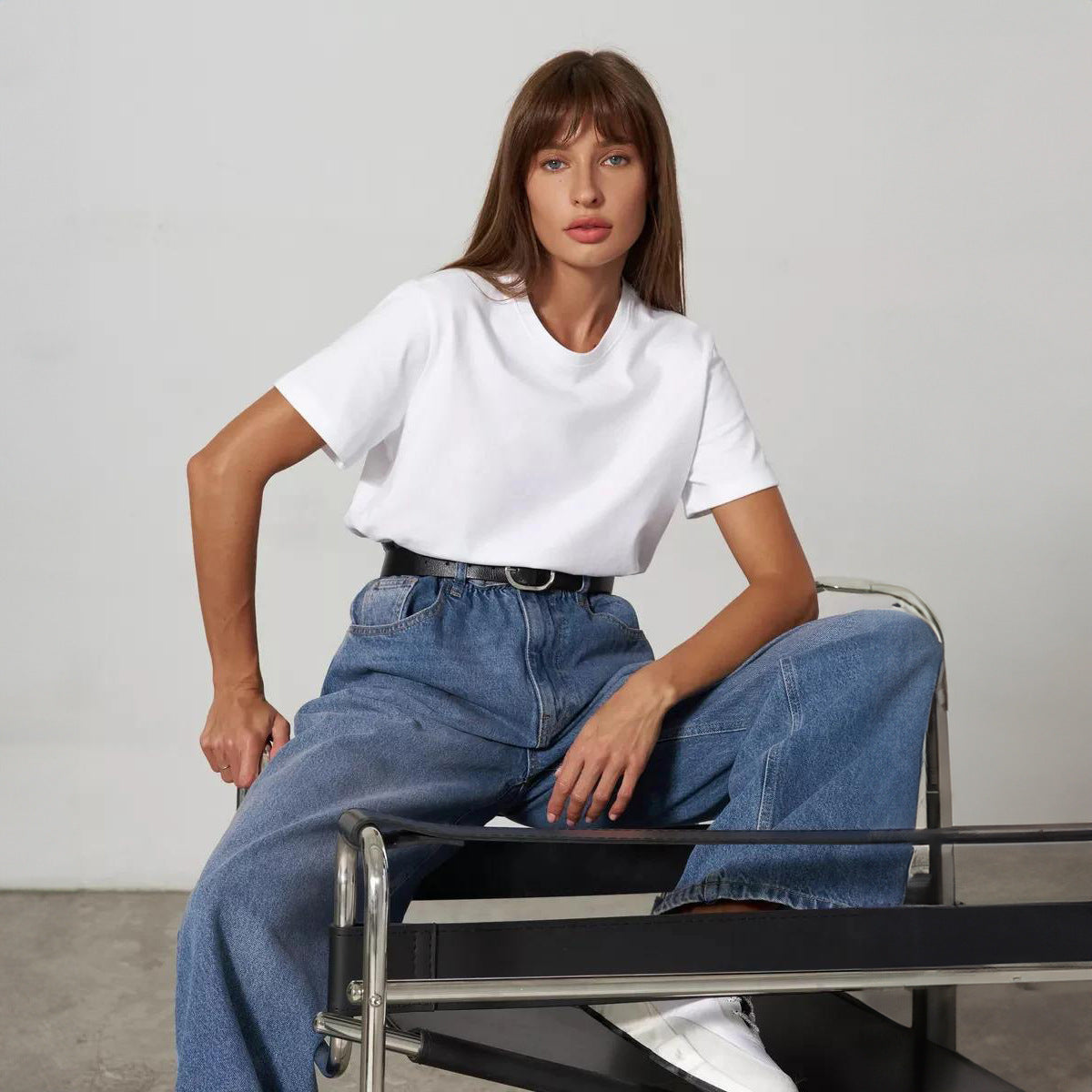 Everyday Cotton Short Sleeve Crew Tee in White — seated on model, tucked into jeans