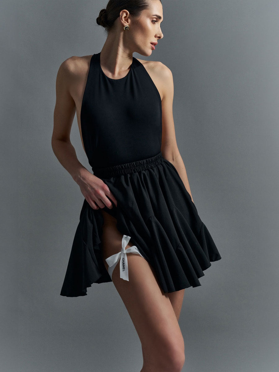 Pleated Bubble Mini Skirt in Black — front view on model