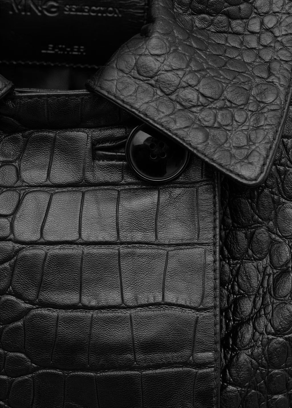Cropped Double-Breasted Faux Leather Jacket in Black — close-up of the croc-embossed texture