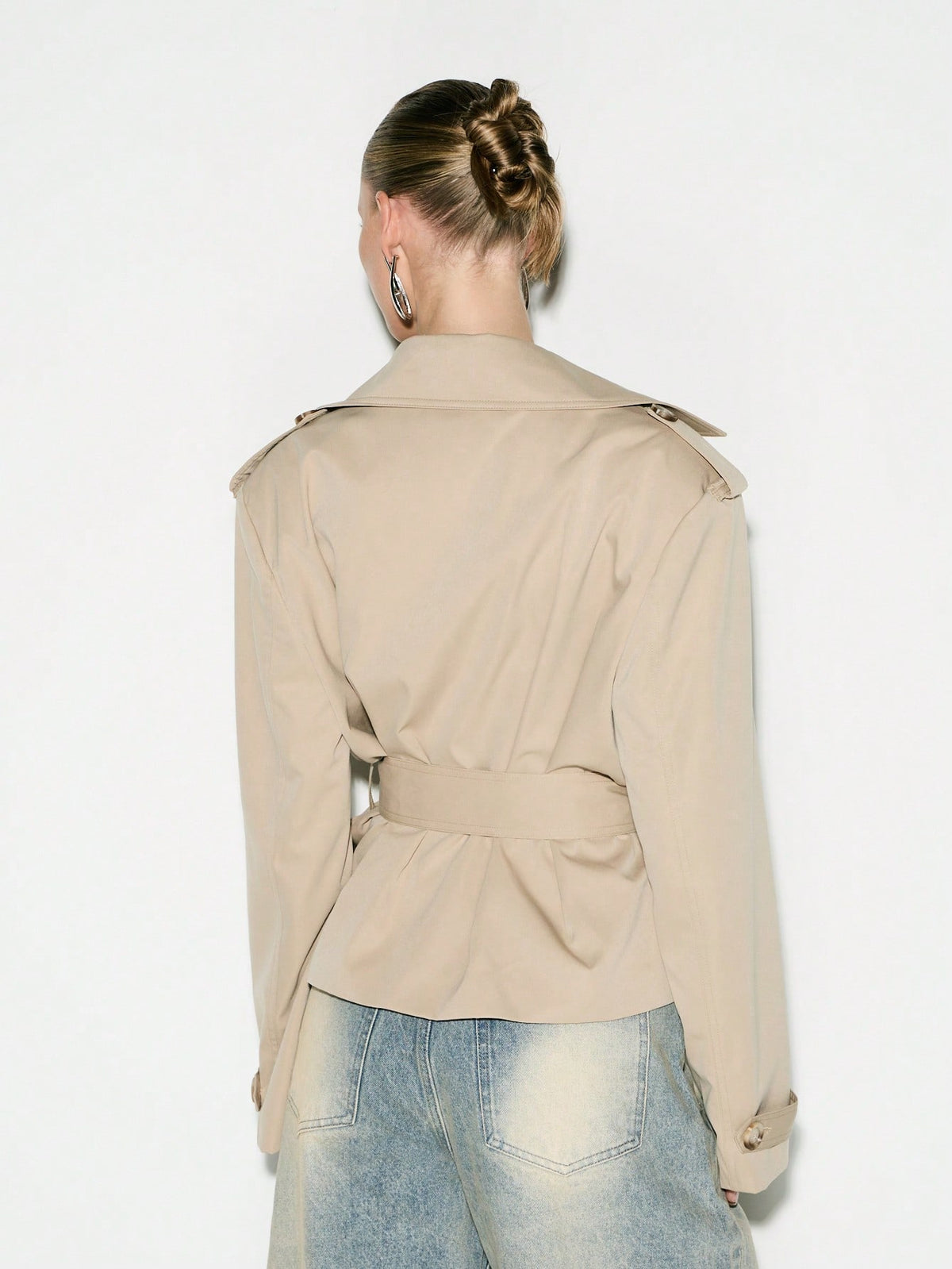 Cropped Double-Breasted Trench Jacket with Belt and Epaulettes in Khaki — back view on model