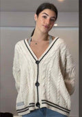 Star-Elbow Cable Knit Cardigan in Ivory with Black Trim — front view on model