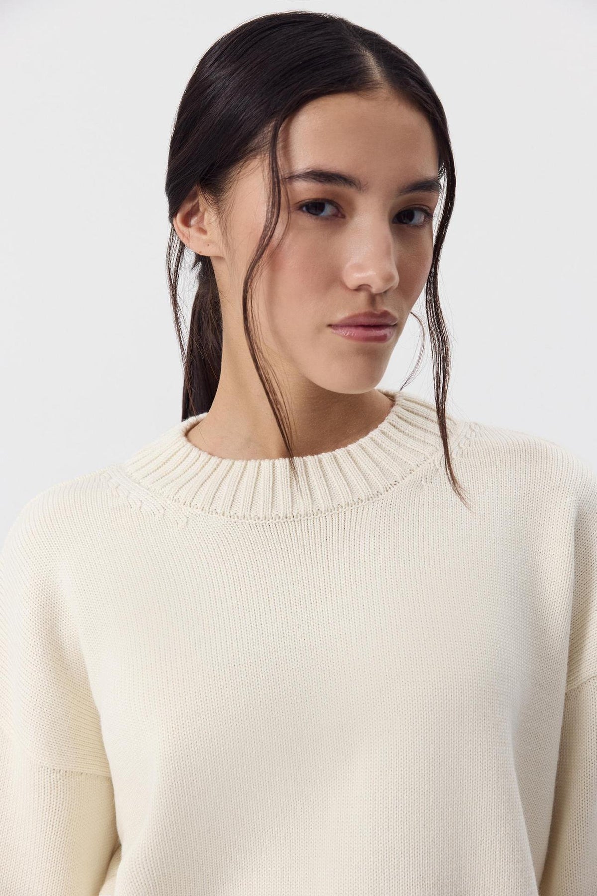 Relaxed Cotton Crew Neck Sweater with Ribbed Cuffs in Ivory — close view of the crew neck