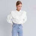 Cotton Ruffle Collar Button-Down Blouse in White — front view on model, tucked into jeans