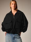 Oversized Half-Zip Funnel-Neck Windbreaker Jacket in Black — front view on model