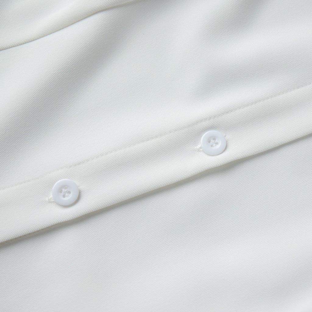 Sleeveless Button-Front Collared Maxi Dress in White — close-up of the buttons