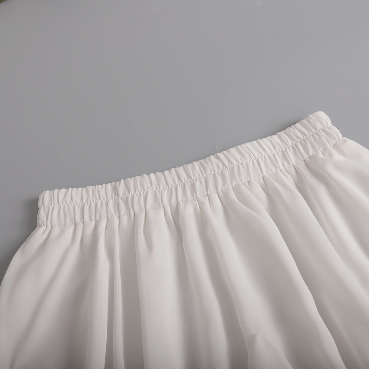 Pleated Bubble Mini Skirt in White — close-up of pleats