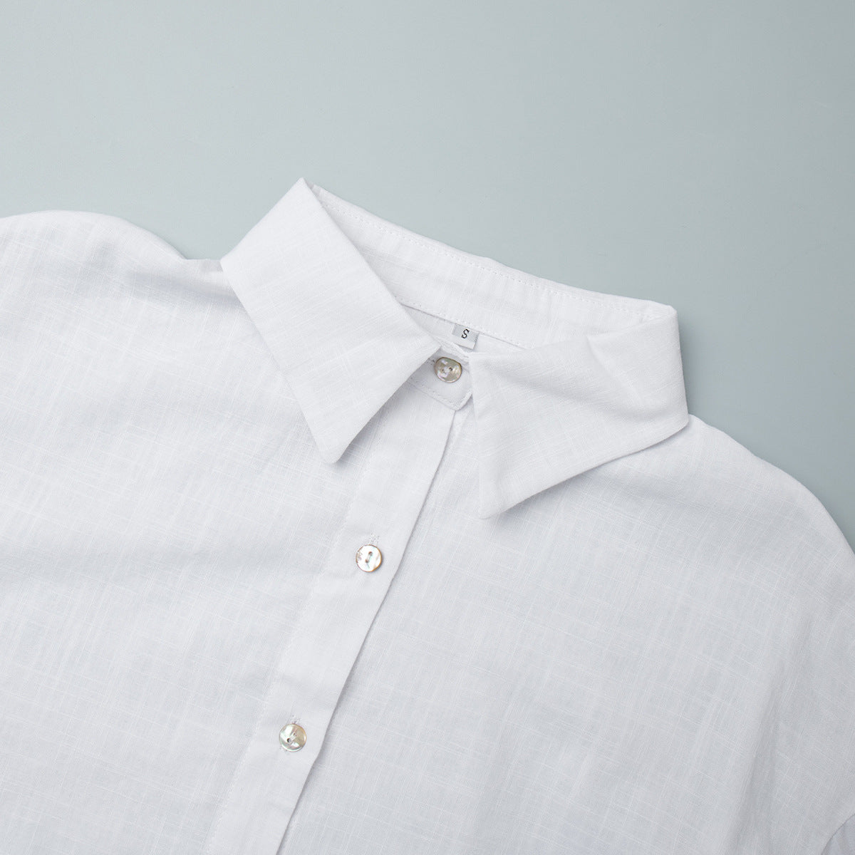 Relaxed Cotton Button-Down Shirt in White — close-up of the pointed collar