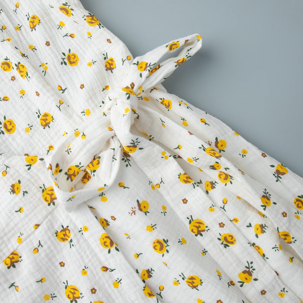 Cotton Floral Puff-Sleeve Wrap Midi Dress in Yellow Floral — close-up of the waist tie