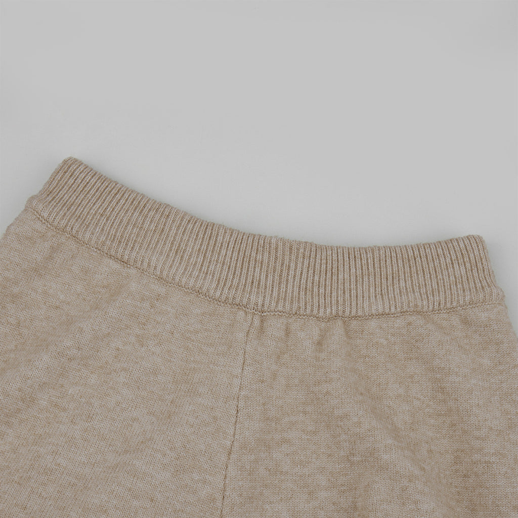 Three-Piece Knit Set: Zip-Up Cardigan, Sleeveless Top & Wide-Leg Pants in Oat — close-up of the pants waistband