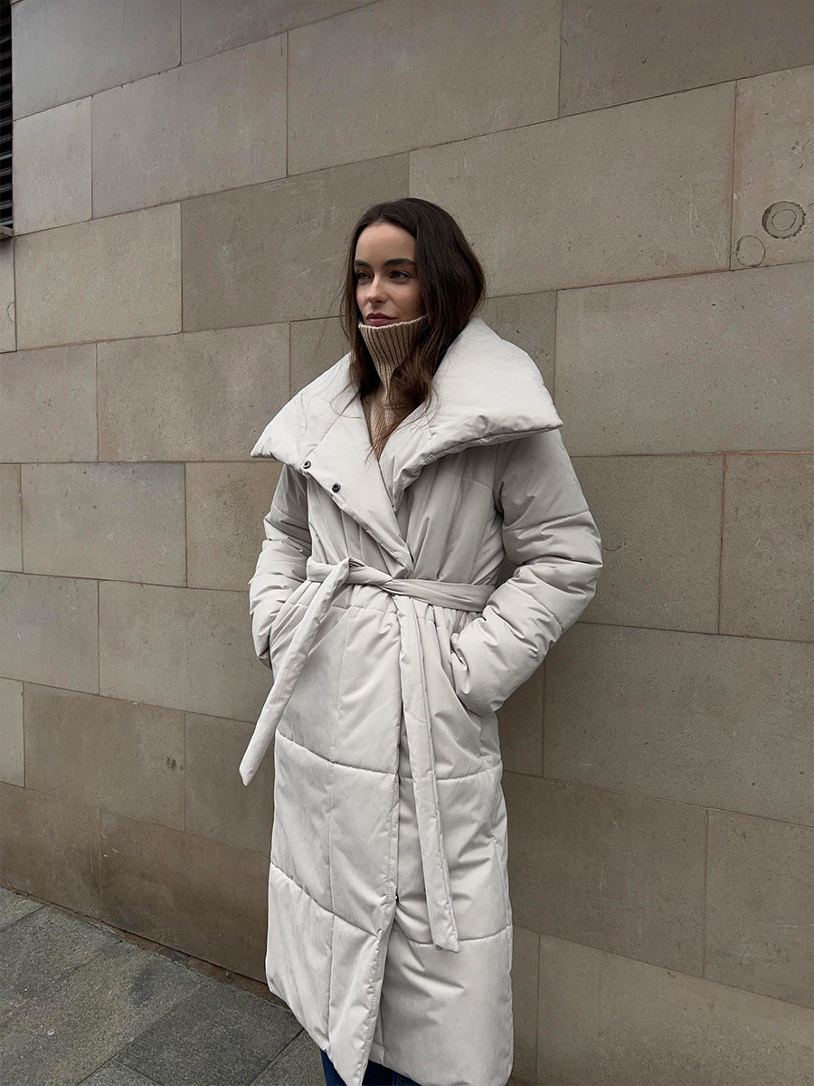 Long Belted Puffer Coat with Oversized Collar in Cream — front view on model, belted
