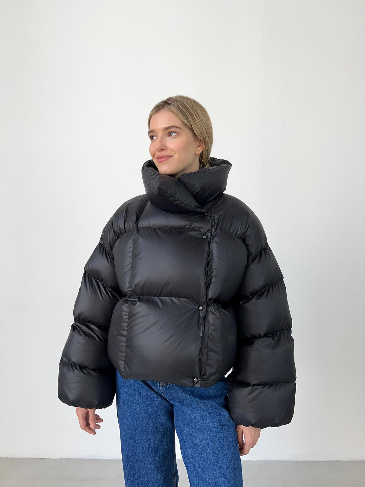 Cropped Hooded Puffer Jacket with Drawstring Hem in Black — front view on model
