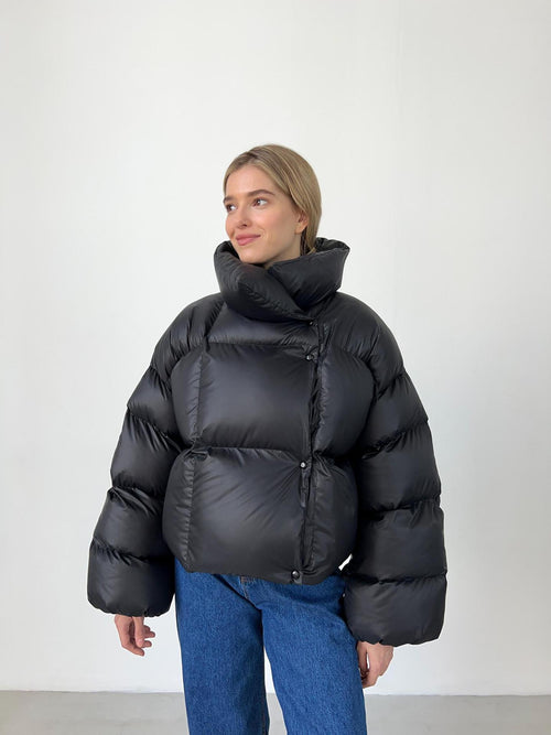 Cropped Hooded Puffer Jacket with Drawstring Hem in Black — front view on model