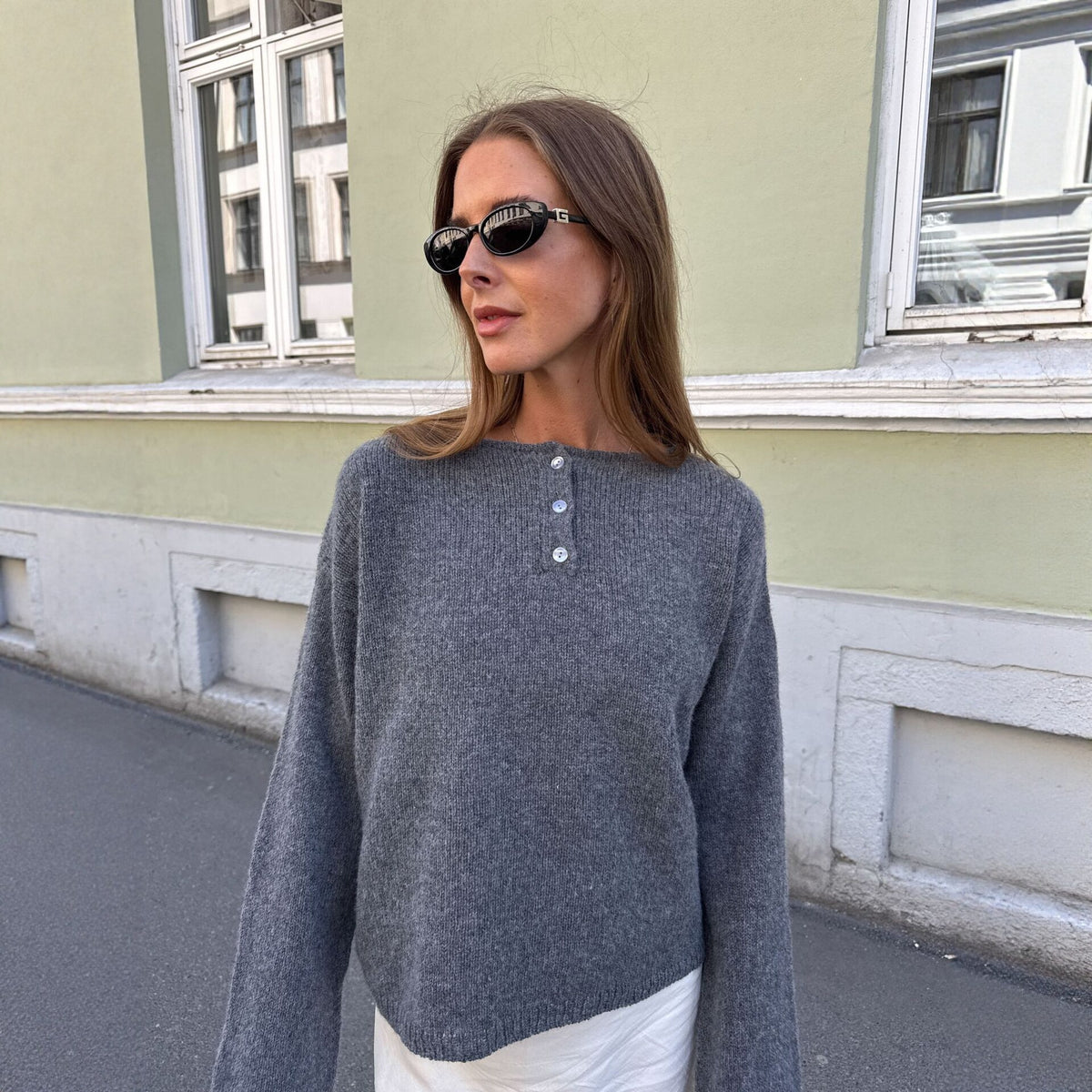 Relaxed Henley Sweater with Button Placket in Charcoal Gray — front view on model