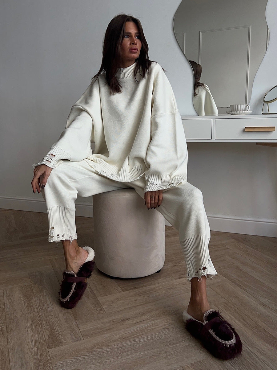Distressed-Hem Oversized Knit Sweater & Jogger Set in Cream — seated view on model