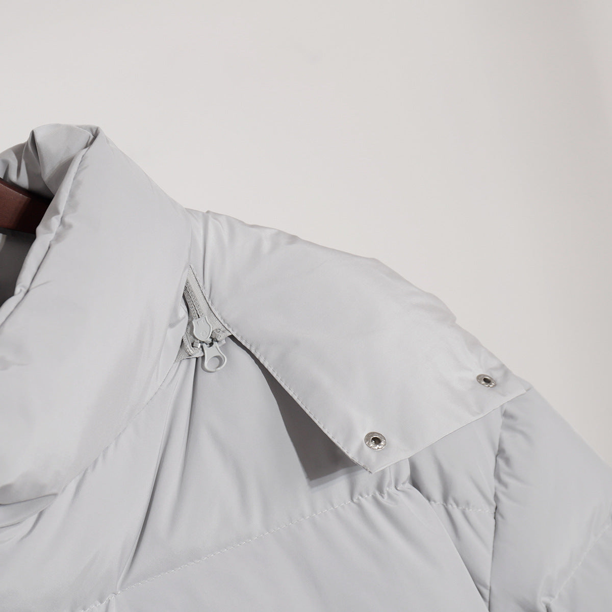 Matte Oversized Hooded Puffer Jacket in Light Gray — close-up of the collar snap and zip