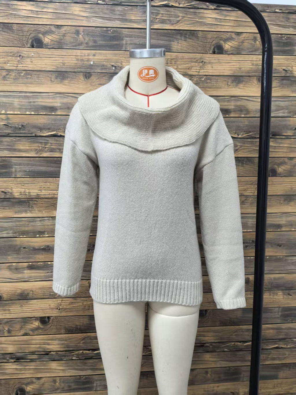 Oversized Cowl-Neck Knit Sweater in White — front view on a dress form