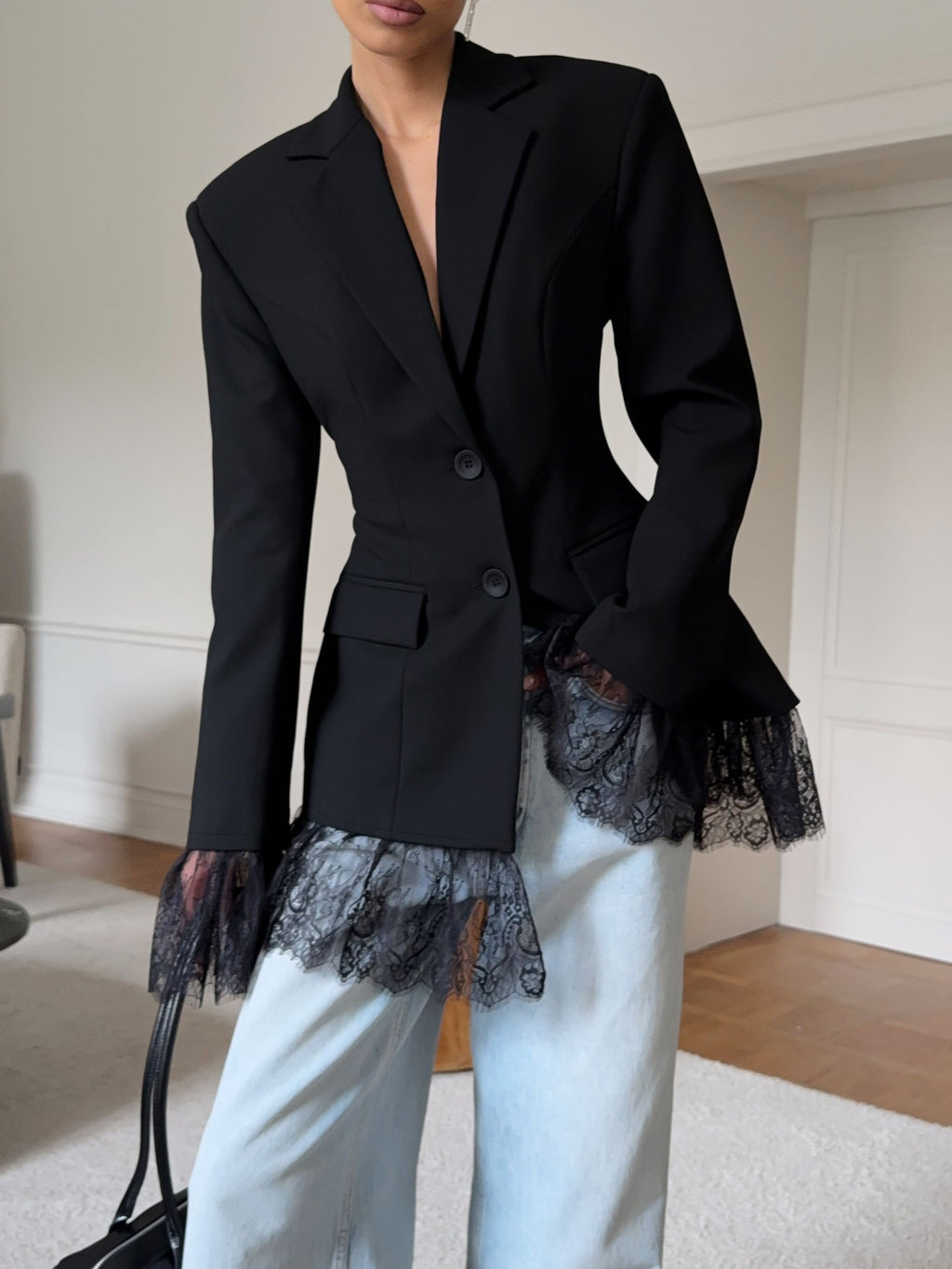Fitted Blazer with Lace-Trimmed Hem and Cuffs in Black — front view on model