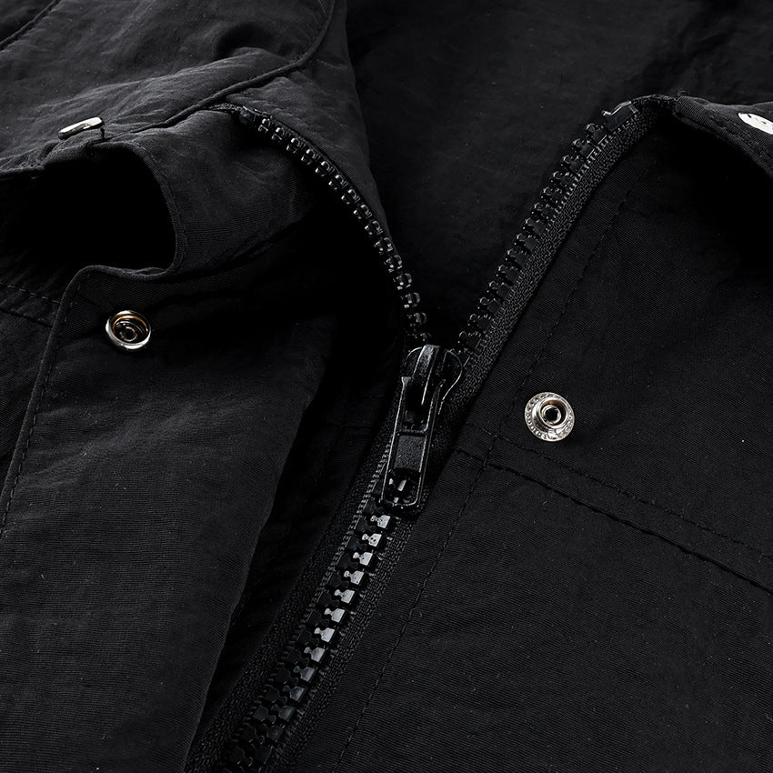 Oversized Stand-Collar Nylon Jacket with Drawcord Hem in Black — close-up of the zip and snap placket
