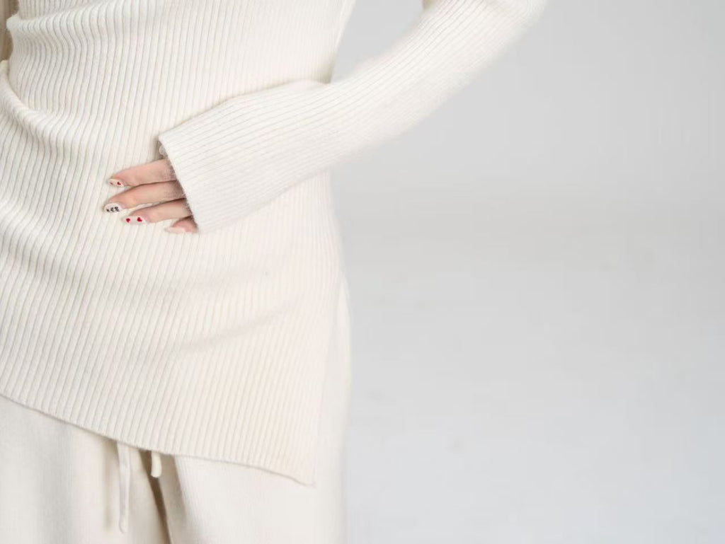 Asymmetric Off-Shoulder Rib-Knit Top & Wide-Leg Pants Set in Cream — close-up of the rib knit and angled hem