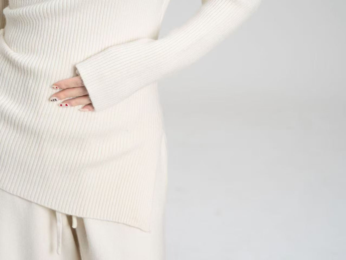 Asymmetric Off-Shoulder Rib-Knit Top & Wide-Leg Pants Set in Cream — close-up of the rib knit and angled hem