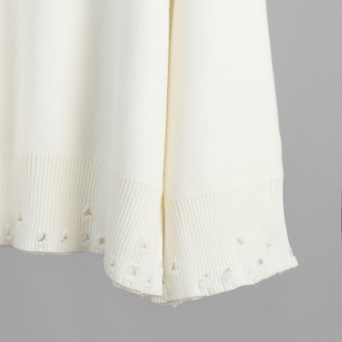 Distressed-Hem Oversized Knit Sweater & Jogger Set in Cream — close-up of the distressed hem