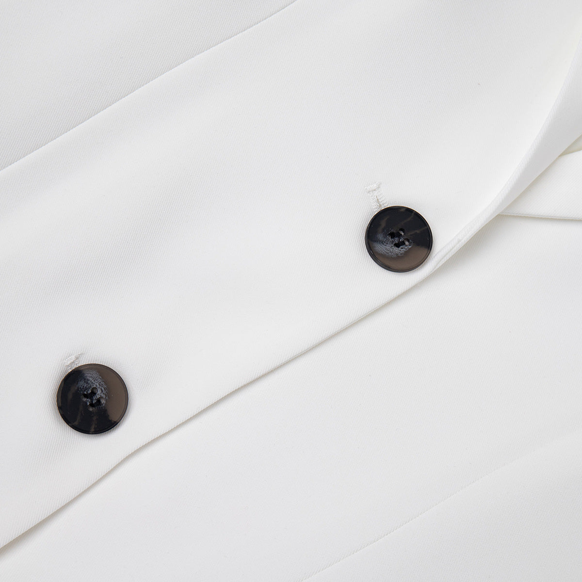 Tailored Two-Button Blazer with Cinched Waist in Ivory — close-up of the two-button front