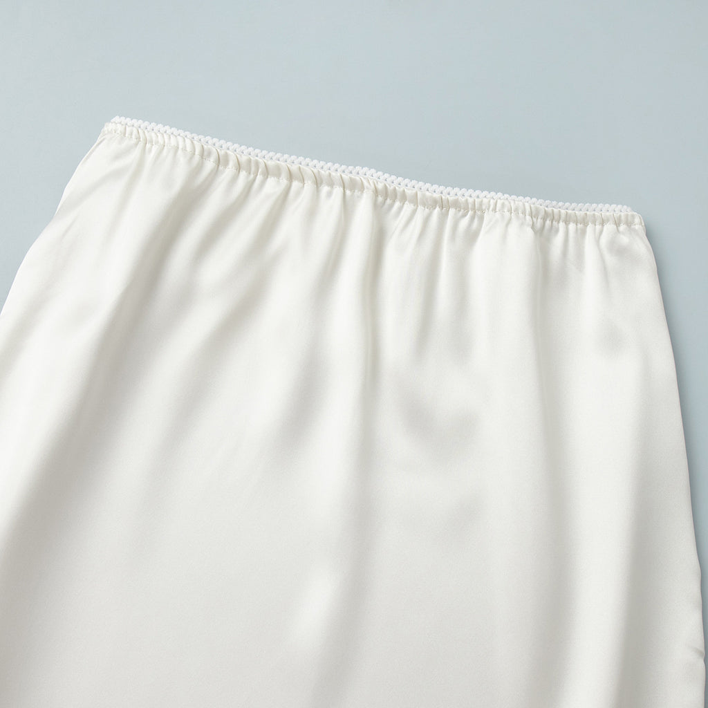 Satin Midi Skirt with Lace Hem in Ivory — close-up of elastic waistband