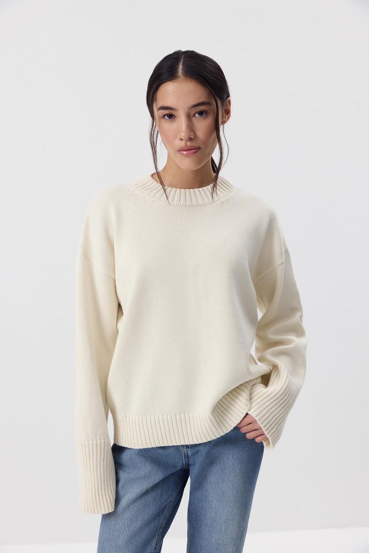 Relaxed Cotton Crew Neck Sweater with Ribbed Cuffs in Ivory — front view on model