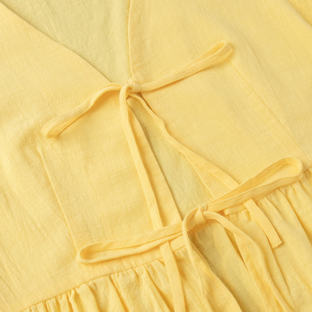 Tie-Front Puff-Sleeve Top & Maxi Skirt Set in Butter Yellow — close-up of the elastic back waist