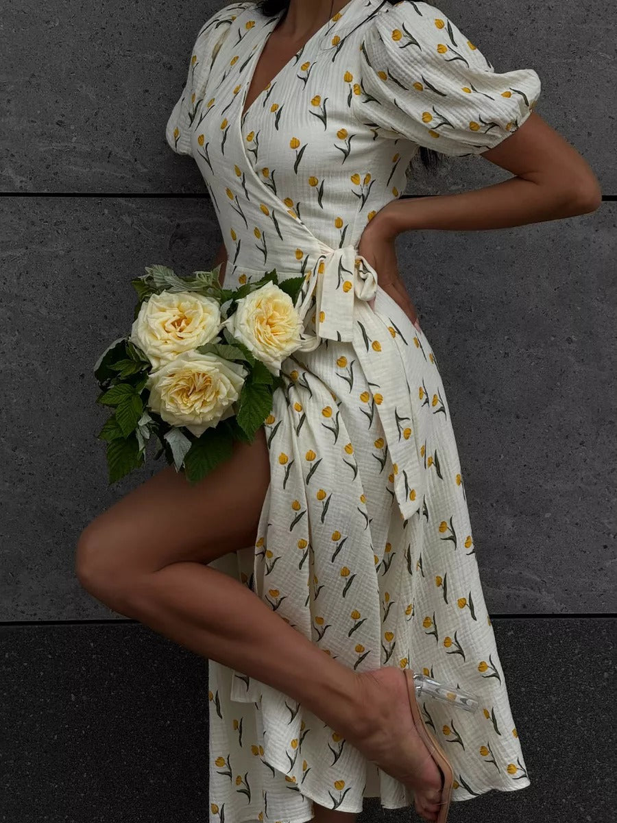 Cotton Puff-Sleeve Wrap Midi Dress in Cream Tulip — front view on model with yellow roses