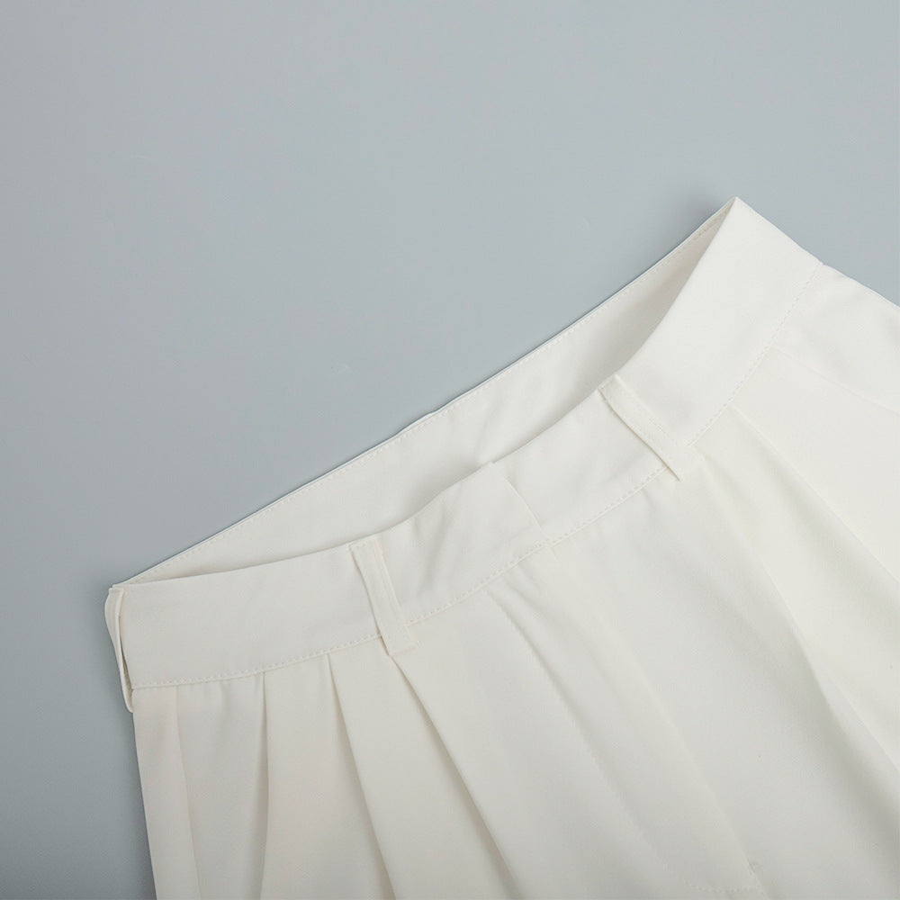 High-Waist Pleated Wide-Leg Trousers in White — close-up of waistband, belt loops, and front pleats