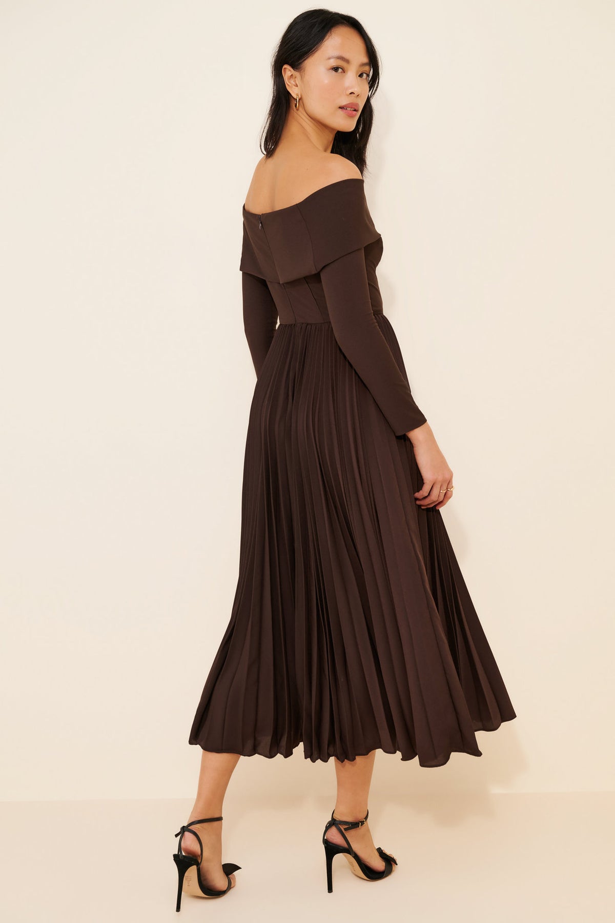 Off-the-Shoulder Long Sleeve Pleated Midi Dress in Chocolate — side view on model