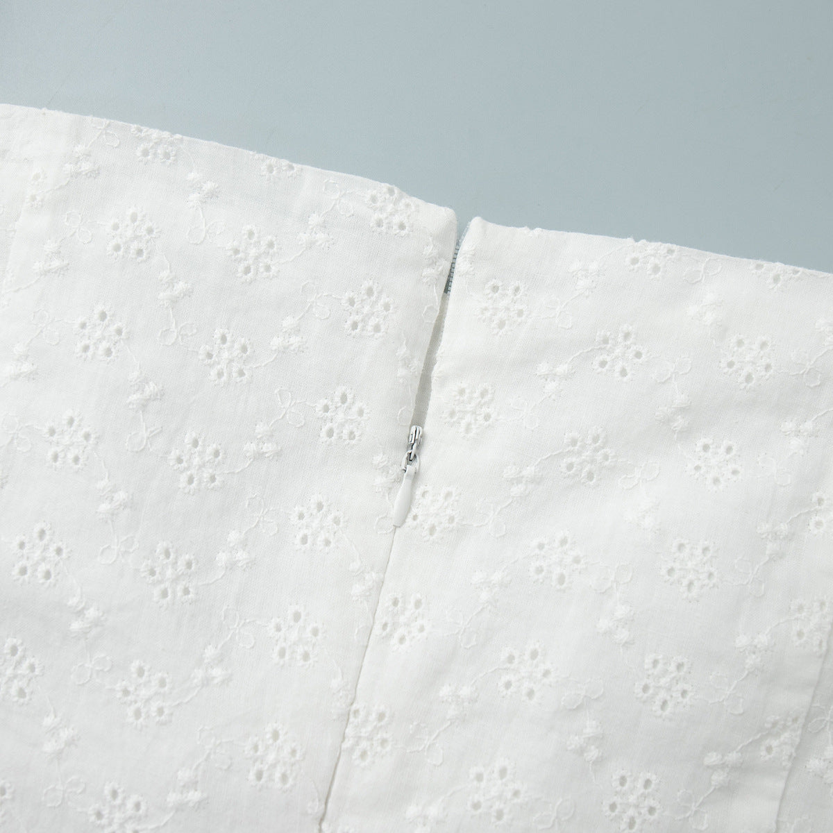 Eyelet Cotton Off-Shoulder Midi Dress in Ivory Eyelet — close-up of back zipper