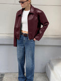 Faux Leather Bomber Jacket with Point Collar in Burgundy — front view on model with jeans