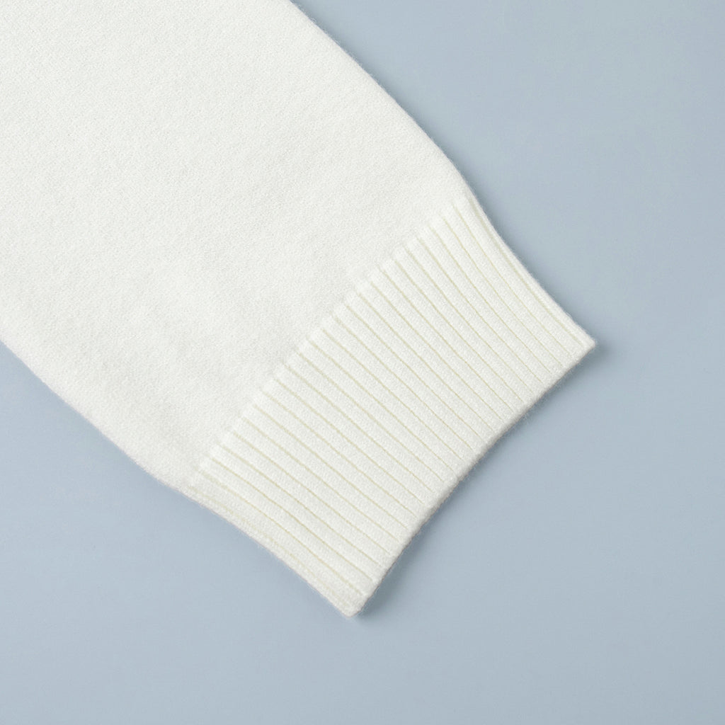 Oversized Turtleneck Sweater & Knit Maxi Skirt Set in Ivory — close-up of the ribbed cuff