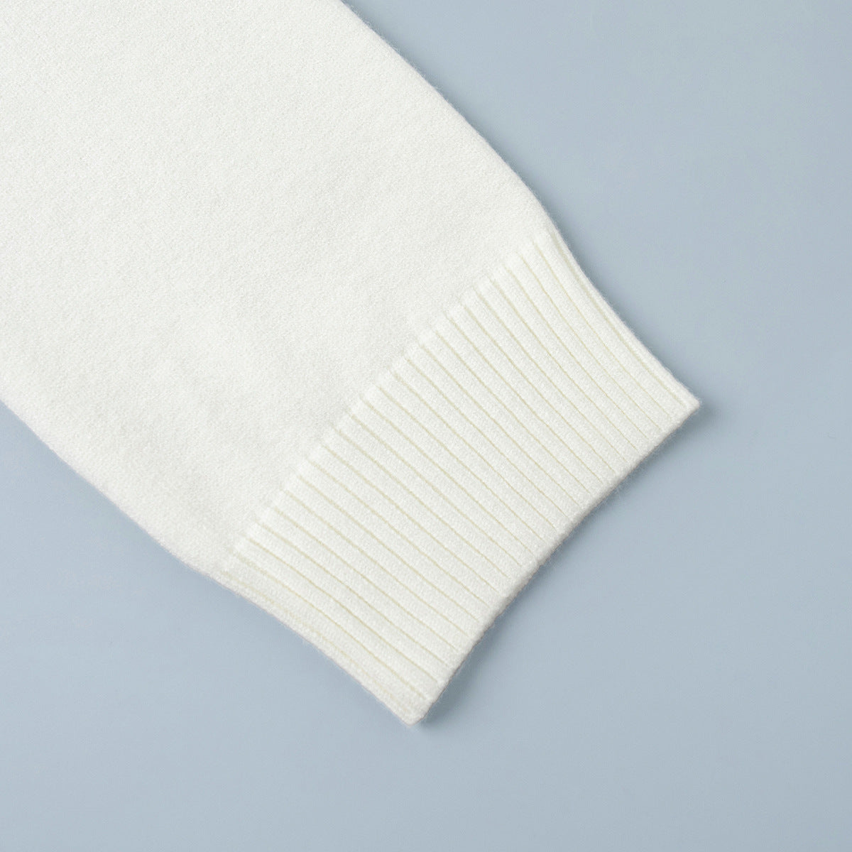Oversized Turtleneck Sweater & Knit Maxi Skirt Set in Ivory — close-up of the ribbed cuff