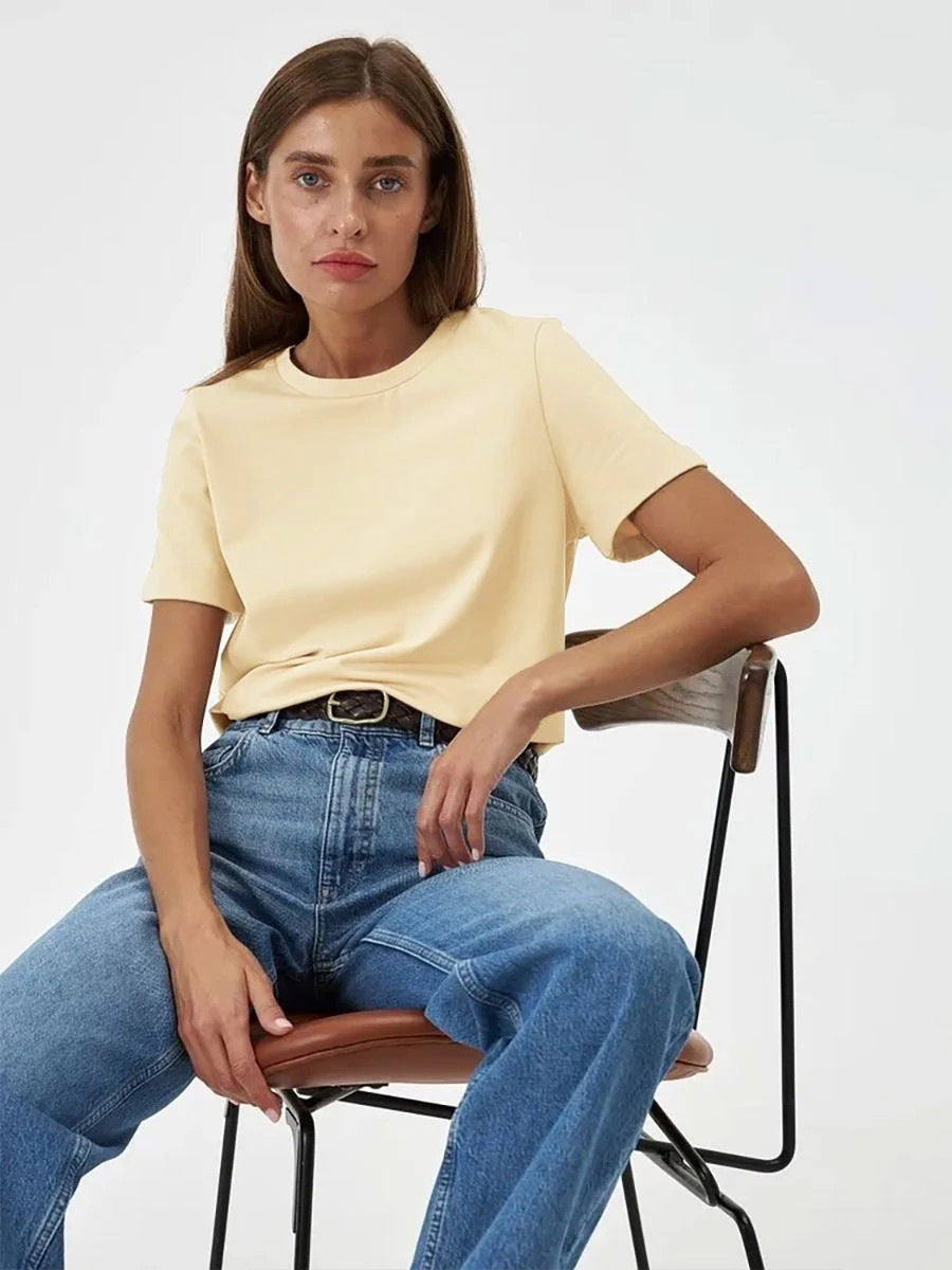 Everyday Cotton Short Sleeve Crew Tee in Apricot — seated on model