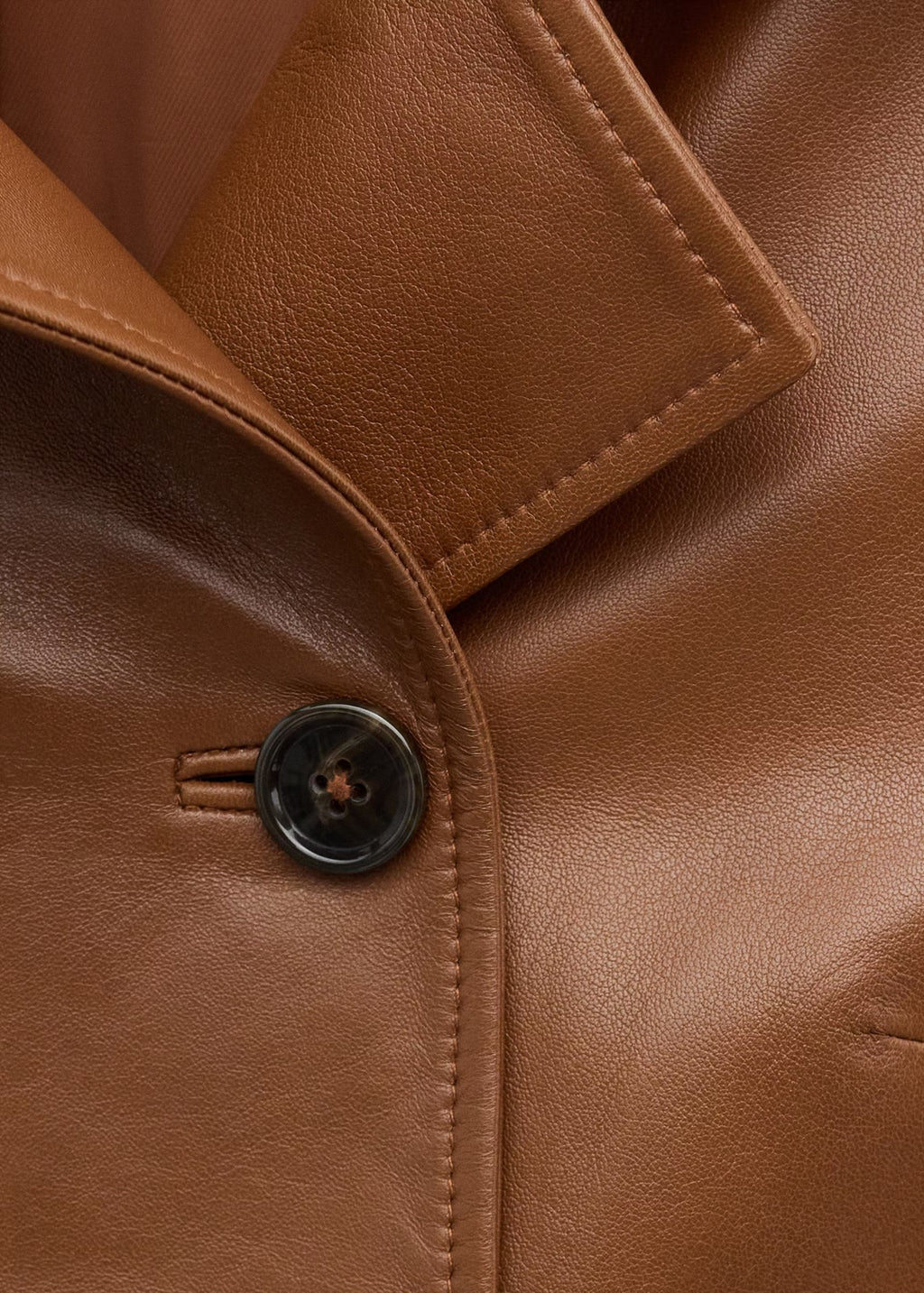 Cropped Double-Breasted Faux Leather Jacket in Cognac — close-up of the collar and button