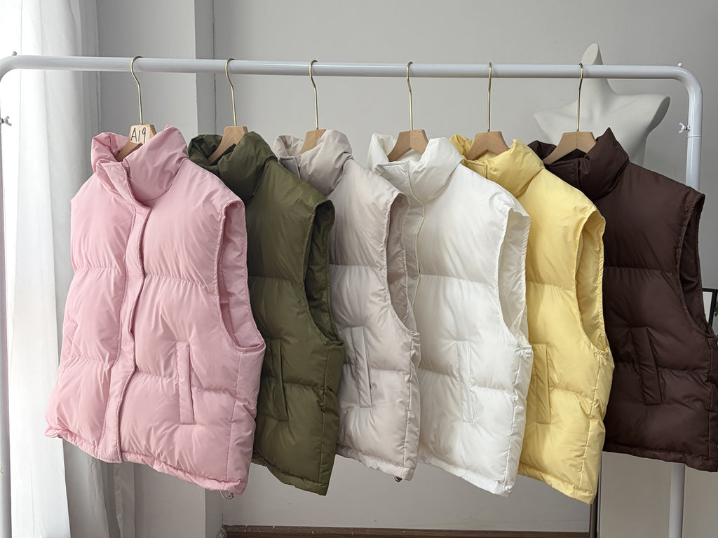 Stand Collar Puffer Vest with Pockets in Soft Pink — all colors on a rack
