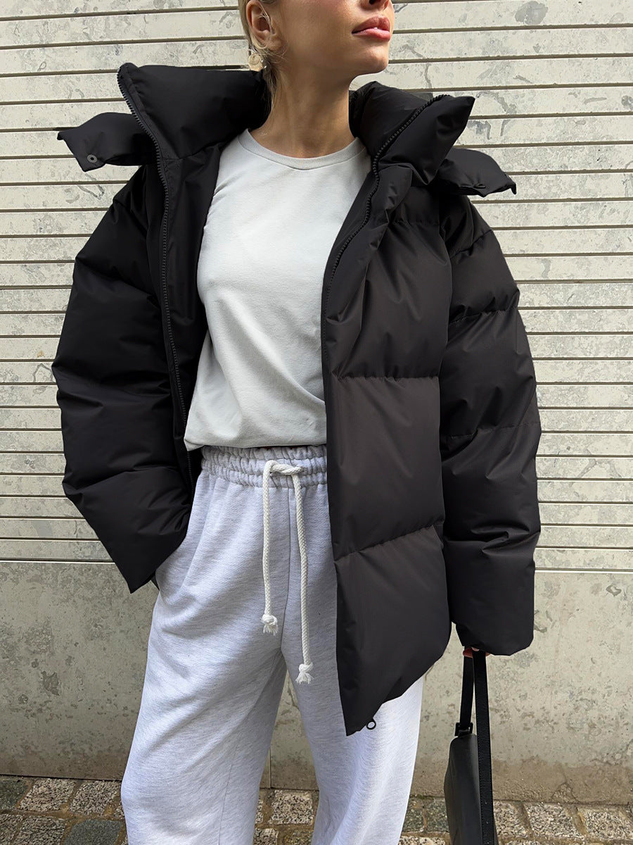 Matte Oversized Hooded Puffer Jacket in Black — worn open over a white tee