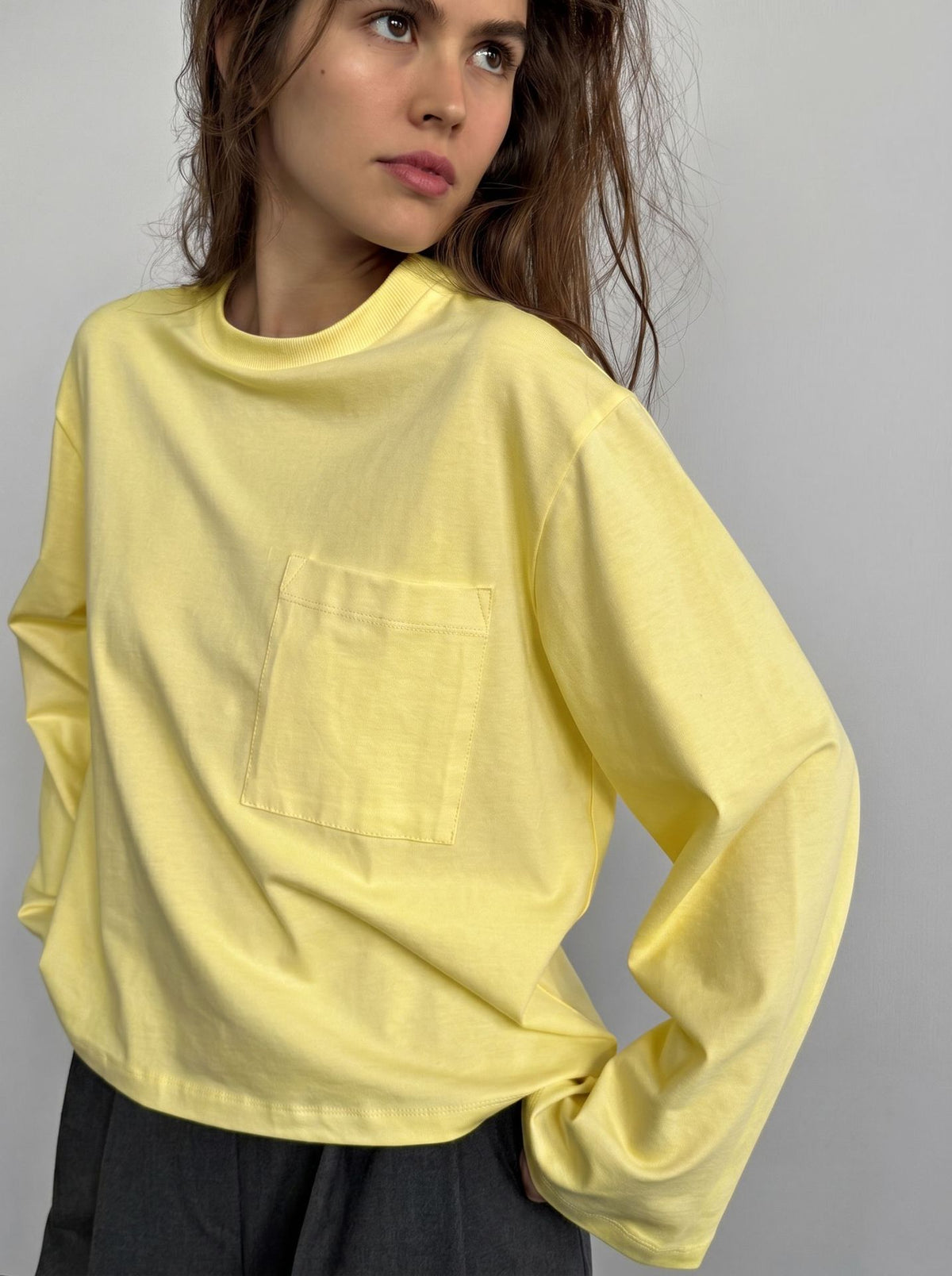 Relaxed Cotton Long-Sleeve Pocket Tee in Butter Yellow — front view on model