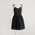 Tie-Shoulder Open-Back Cotton Mini Dress in Black — front view on mannequin